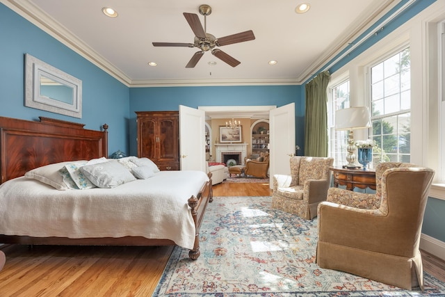 bedroom with ceiling fan, light hardwood / wood-style flooring, and ornamental molding