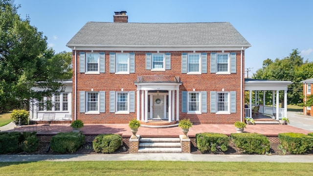 colonial-style house with a front yard