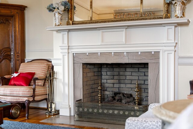 room details featuring crown molding, a fireplace, and hardwood / wood-style flooring