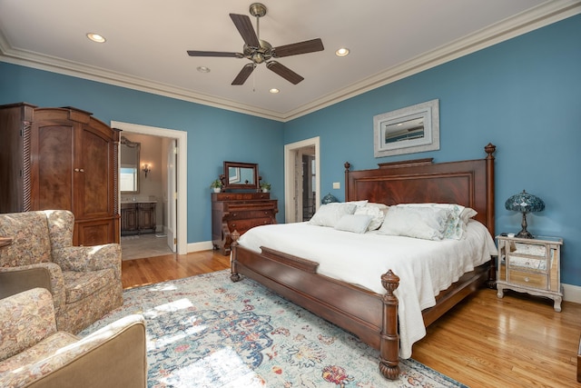 bedroom featuring light wood-type flooring, connected bathroom, ornamental molding, and ceiling fan