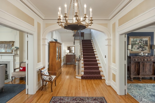 interior space featuring ornamental molding and light hardwood / wood-style floors