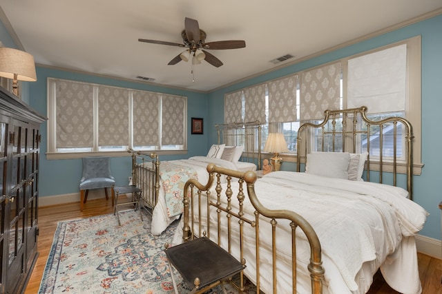 bedroom featuring crown molding, ceiling fan, and hardwood / wood-style flooring