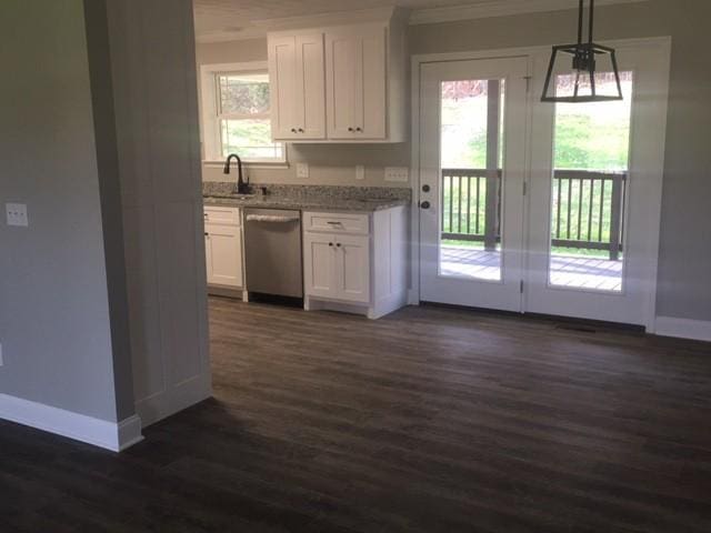 kitchen featuring white cabinetry, dishwasher, sink, dark wood-type flooring, and hanging light fixtures