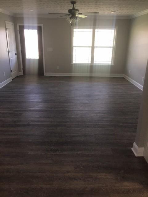 spare room with ceiling fan, crown molding, and dark hardwood / wood-style floors