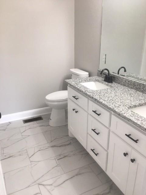 bathroom with vanity and toilet