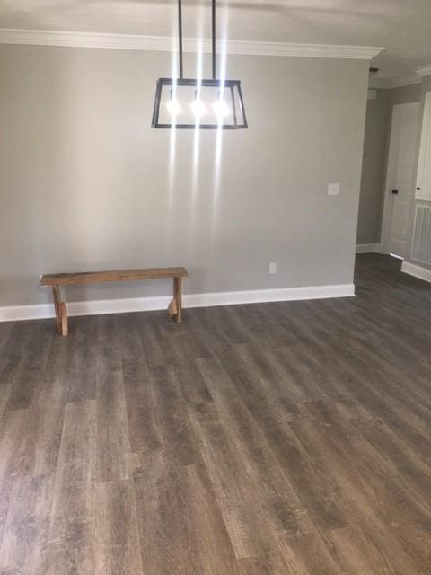 unfurnished dining area with dark hardwood / wood-style floors and ornamental molding