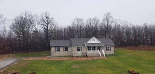 view of front of property with covered porch and a front yard