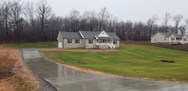 view of front facade featuring a garage, a porch, and a front yard