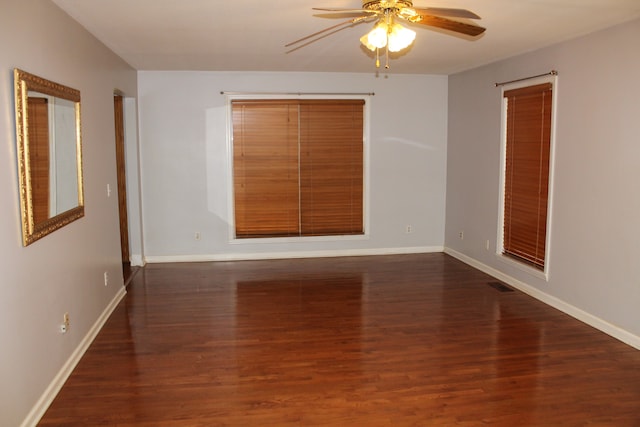 empty room with ceiling fan and dark wood-type flooring