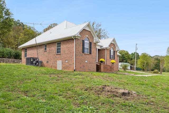 view of property exterior with a lawn and cooling unit