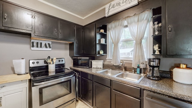 kitchen with appliances with stainless steel finishes, a textured ceiling, dark brown cabinetry, ornamental molding, and sink