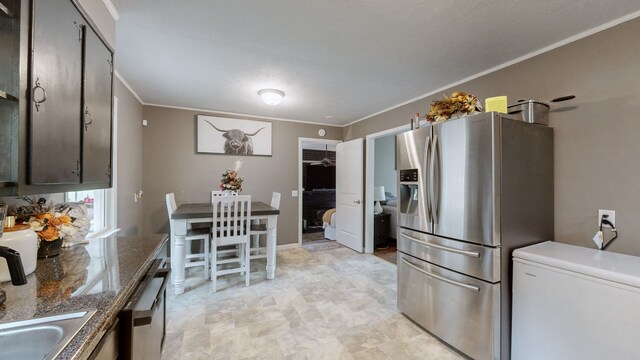 kitchen with crown molding, sink, and stainless steel appliances