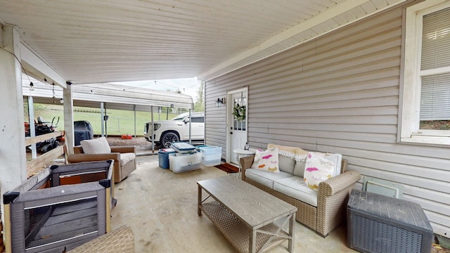 view of patio / terrace with an outdoor living space and a carport