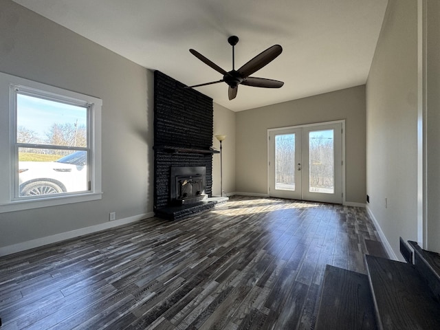 unfurnished living room featuring french doors, dark wood-style flooring, a ceiling fan, and baseboards