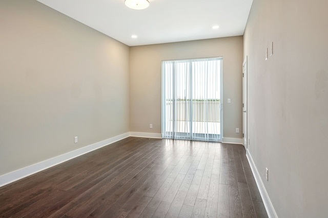 spare room featuring dark wood-type flooring