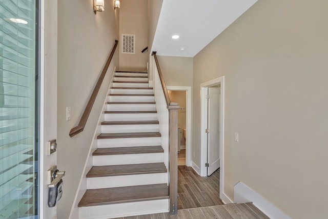 stairs with hardwood / wood-style floors