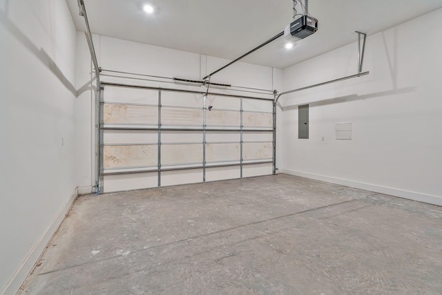 garage with a garage door opener and electric panel