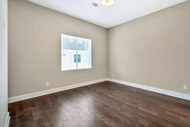 unfurnished room featuring dark wood-type flooring