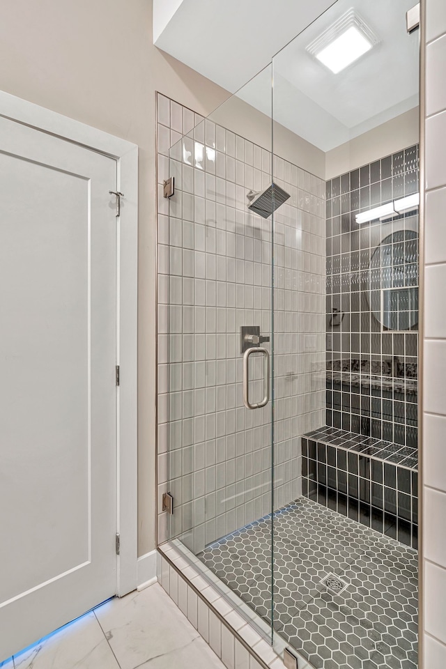 bathroom with a shower with shower door