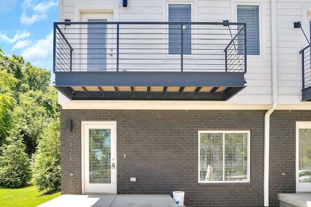 back of house featuring a balcony