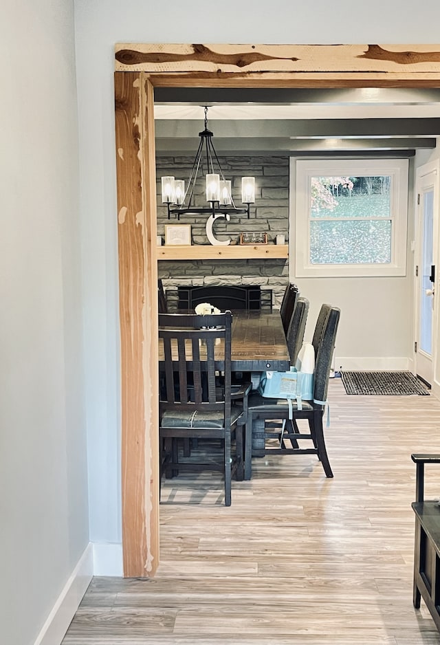 dining area with a chandelier and wood-type flooring