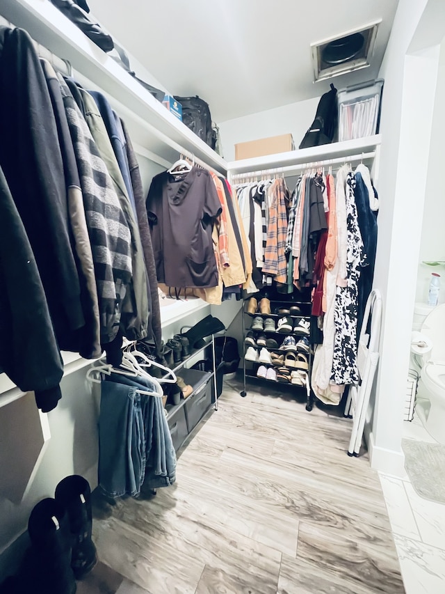 spacious closet featuring hardwood / wood-style floors