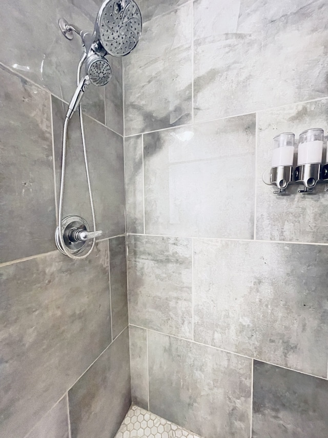 bathroom with tiled shower