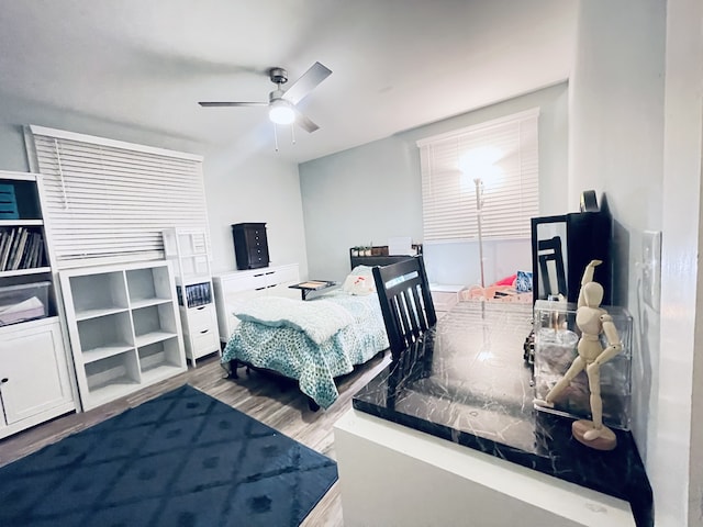 bedroom featuring hardwood / wood-style floors and ceiling fan