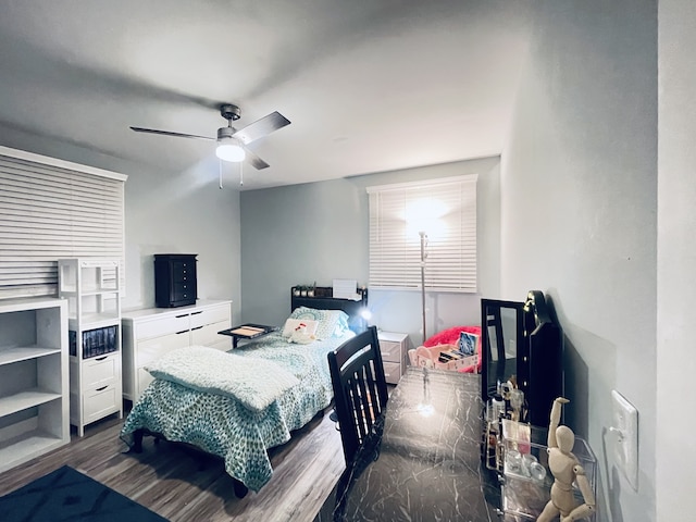 bedroom with dark wood-type flooring and ceiling fan