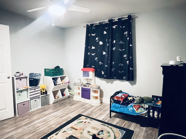 bedroom featuring hardwood / wood-style flooring and ceiling fan