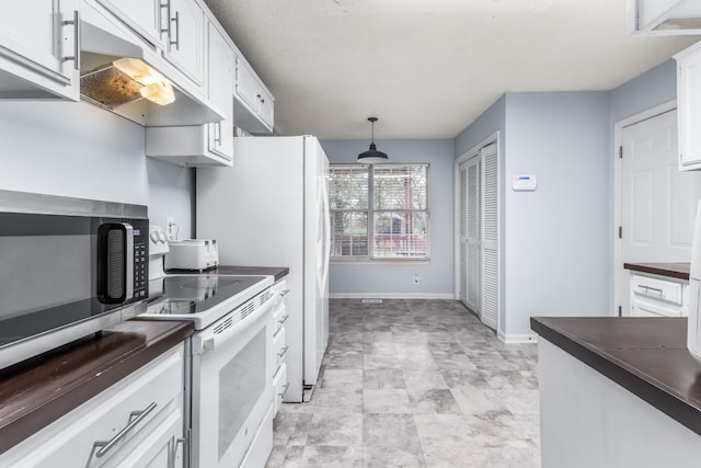 kitchen with white cabinets, electric stove, and hanging light fixtures