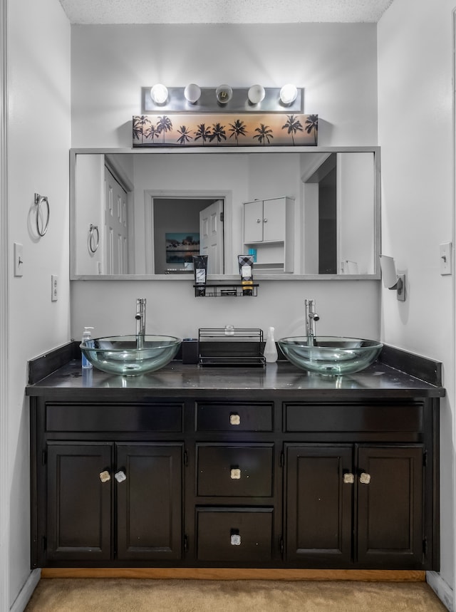 bathroom with a textured ceiling and vanity