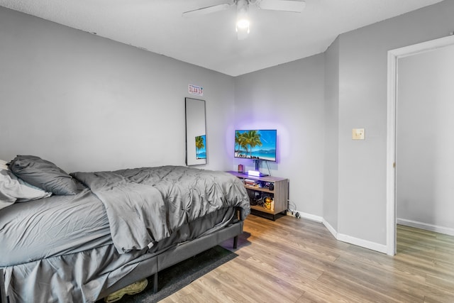 bedroom with ceiling fan and hardwood / wood-style flooring