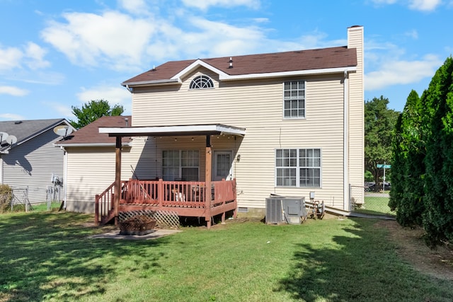 back of house featuring cooling unit, a deck, and a yard