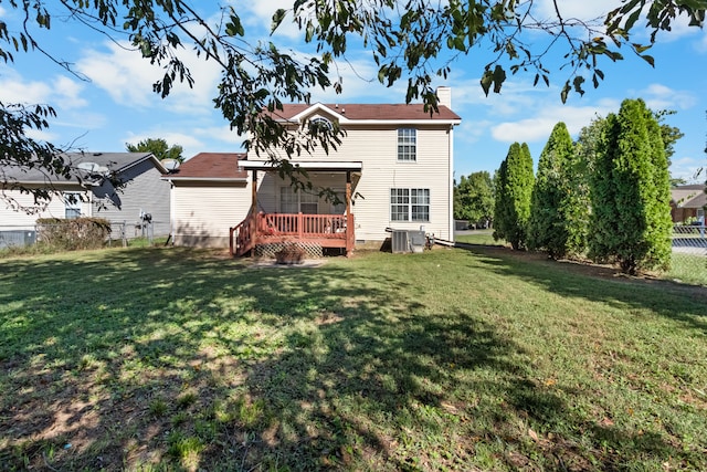 back of house with a yard, ceiling fan, a deck, and central AC