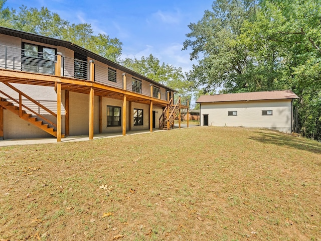 back of house with a wooden deck and a yard