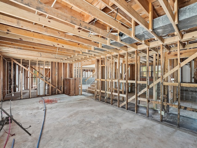 miscellaneous room with gas water heater, concrete floors, and a wealth of natural light