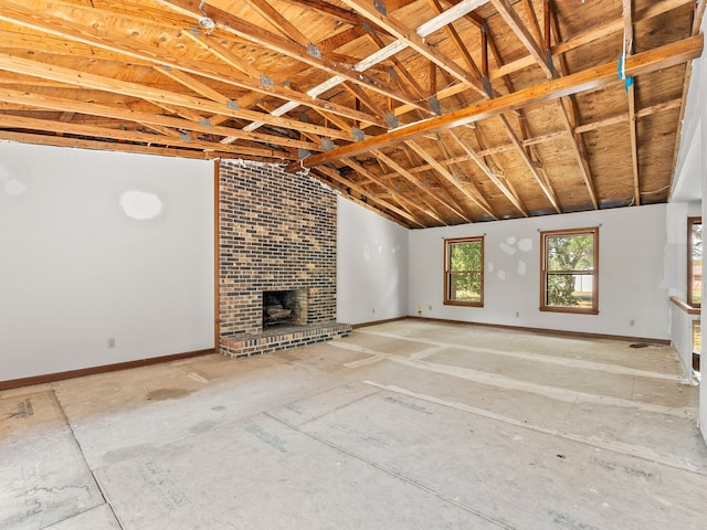 unfurnished living room featuring a fireplace and lofted ceiling