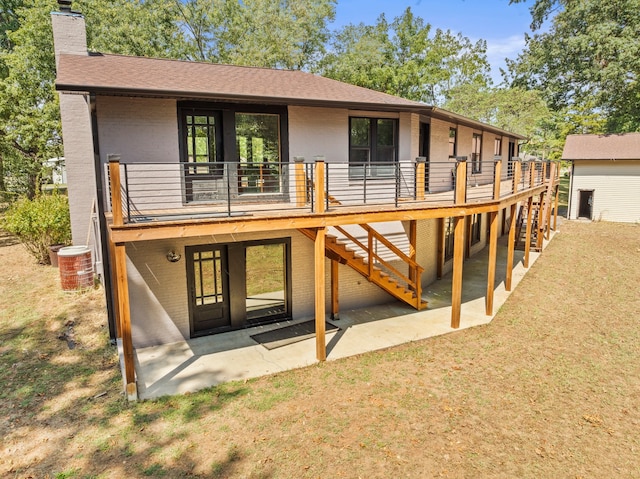 back of property with french doors, a deck, and a patio