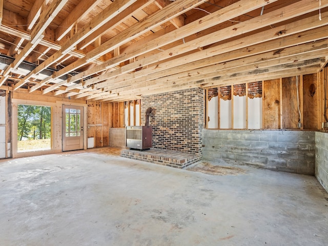 misc room with concrete floors and a wood stove