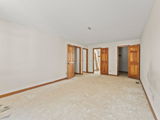 unfurnished room with a textured ceiling