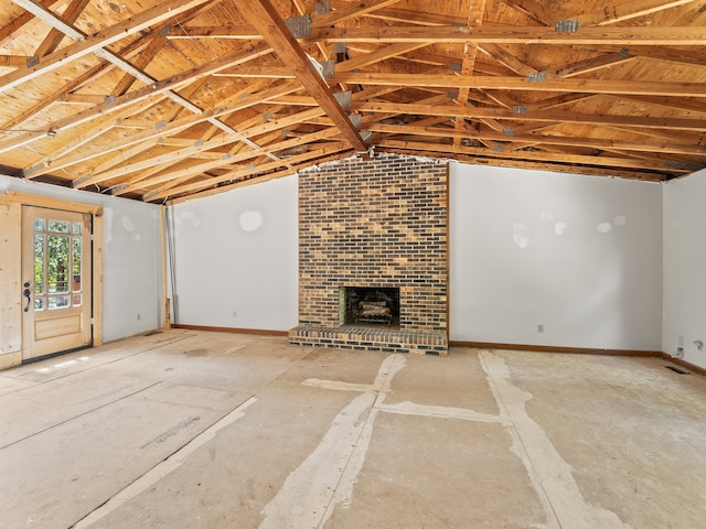 unfurnished living room with a fireplace and vaulted ceiling