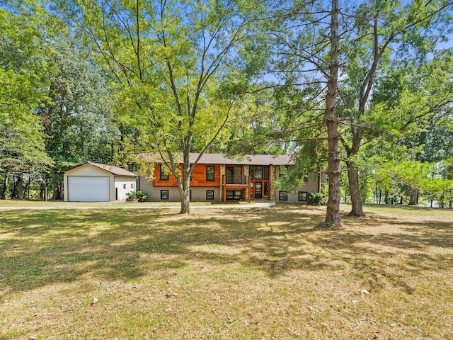 view of front of property featuring a garage and a front lawn