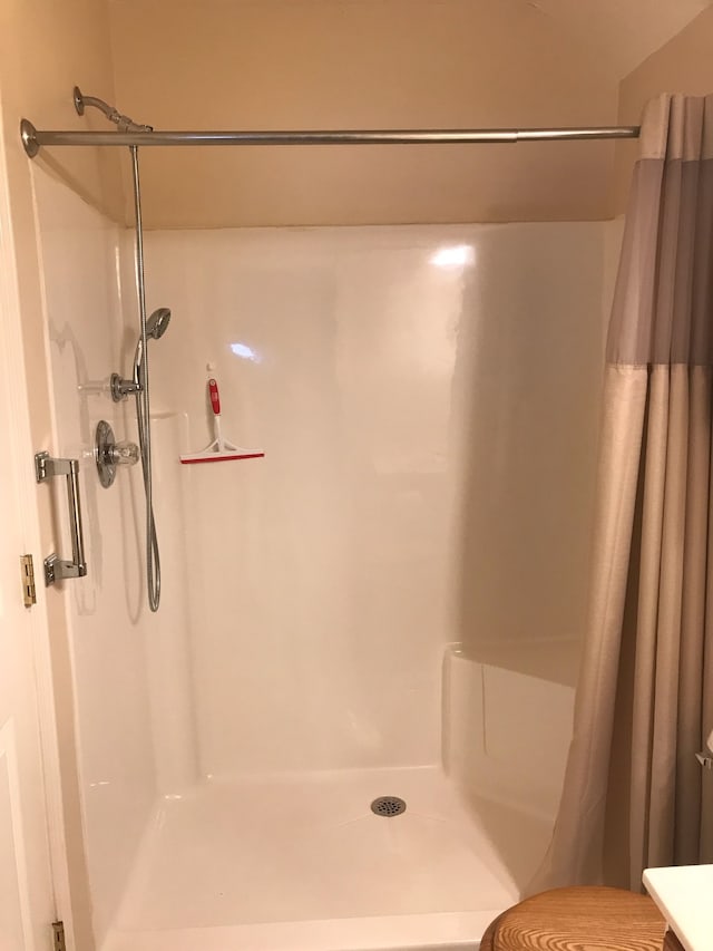 bathroom with a shower with curtain