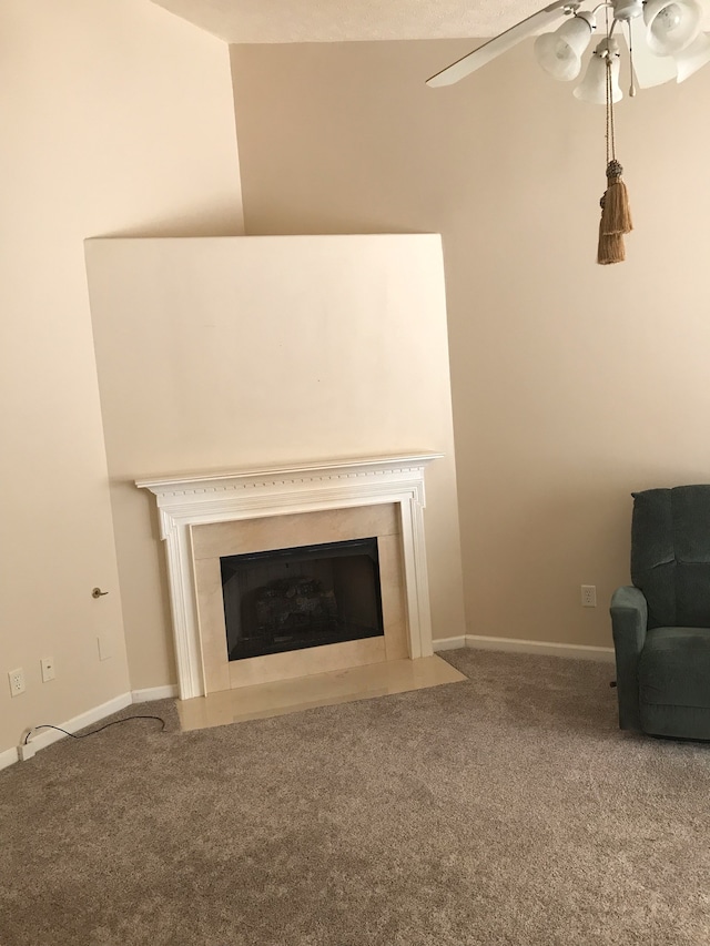 interior space with vaulted ceiling, carpet flooring, and ceiling fan