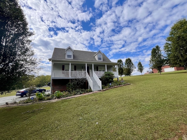 view of front facade with a front yard and covered porch