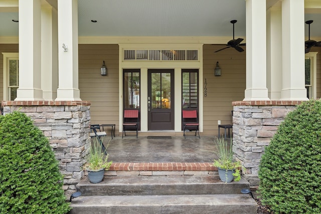 view of exterior entry with ceiling fan and covered porch