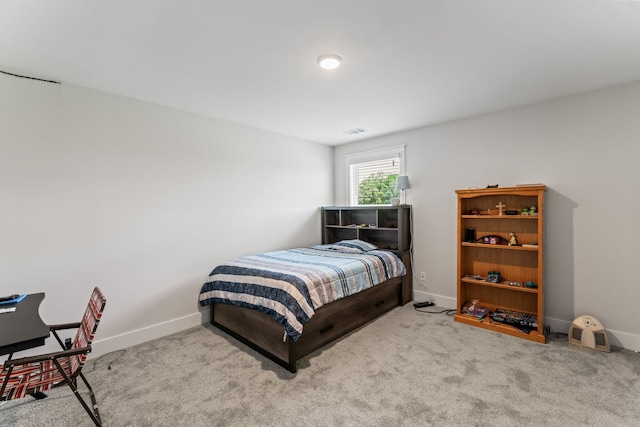 bedroom featuring light colored carpet