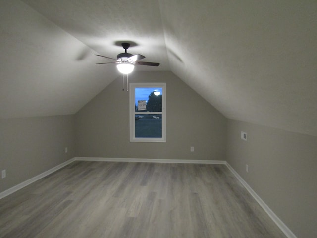 additional living space with lofted ceiling, ceiling fan, and light hardwood / wood-style flooring