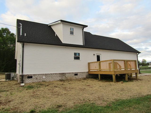 back of house with a deck and central air condition unit